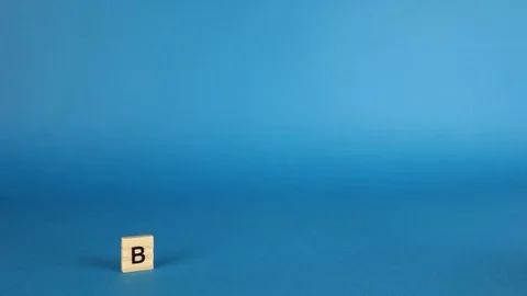 Stop motion books are placed on top of each other and wooden cubes with the word Stock Footage 120145729