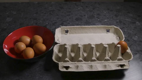 Stop Motion Brown Eggs Moving Between Carton And Red Bowl Stockbeeldmateriaal 339143859