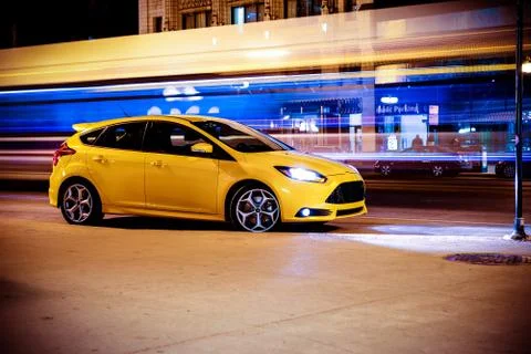 Stop motion car concept. speeding motion blurred traffic and yellow sports ca Stock Photos