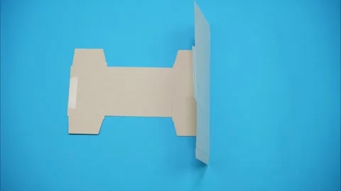 Stop Motion Cardboard Box Folding from Flat Die Cut on Blue Background 库存影片 339362739