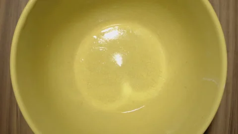 Stop motion chopped raw potatoes in a yellow earthen bowl. Vídeo Stock 134995212