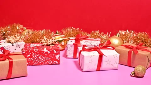 Stop Motion of Christmas Gifts Dancing on Pastel Pink and Red Background Stock-Footage 255367648