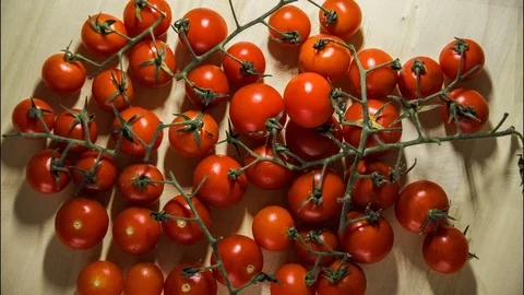 Stop motion of cleaning beautiful tiny toamatoes and put them to order Video stock 98964675