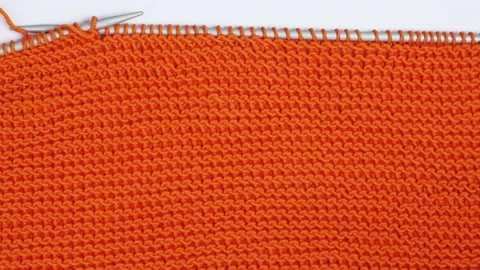 Stop motion close up animation knitted texture. Orange knitted fabric Stock Footage 145831011