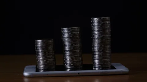 Stop motion coins stack increase on smart phone Video stock 98636274