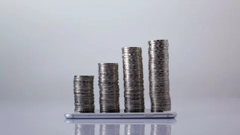 Stop motion coins stack increase on smart phone , business growth and success Video stock 98766608