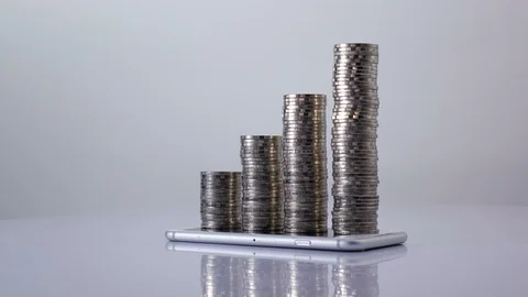 Stop motion coins stack increase on smart phone , business growth and success Video stock 98766622