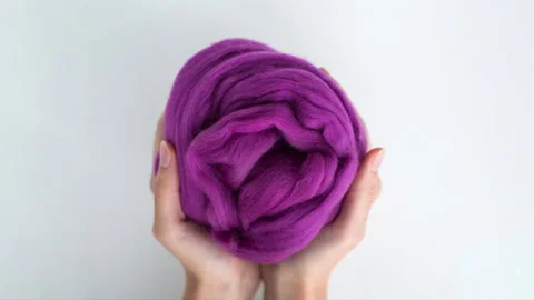 Stop motion, colored balls of merino wool change in female hands Stock Footage 145674339