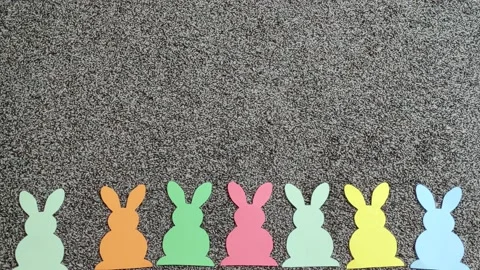 Stop motion colorful paper Easter bunnies gradually fill the screen. Stock Footage 152277128