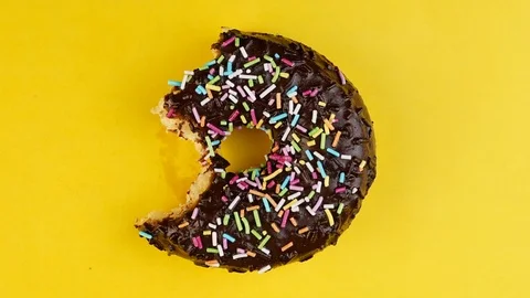 Stop motion creative concept video animation donut bite on yellow background. Stock-Footage 127420327
