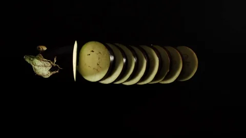 STOP MOTION: Cutting A Fresh Eggplant On A Black Surface Video stock 115958403