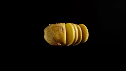 STOP MOTION: Cutting A Fresh Potato On A Black Surface Vídeo Stock 115958393
