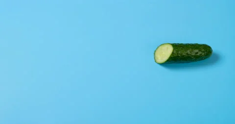 Stop motion of cutting out a fresh cucumber piece by piece and then reversed Stock Footage 162004397