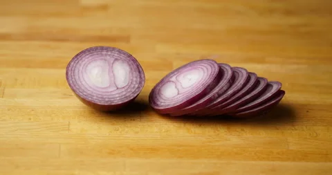 Stop motion cutting red onion on wooden cutting board Stock Footage 98061457
