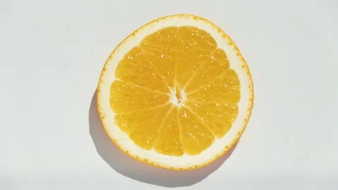 Stop motion of dancing orange slice on white background Stock Footage 117063353