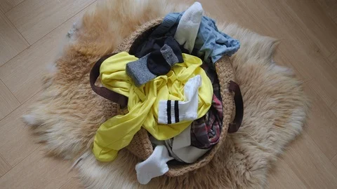 Stop Motion of dirty clothes are filling into a linen laundry basket on a floor Vidéo 124887487