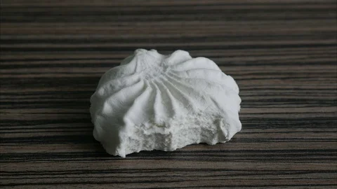 Stop motion eating marshmallow on the table. Stock Footage 72493721