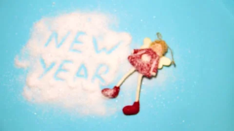Stop motion.The emerging inscription New Year with a New Year's Christmas toy Stock Footage 220681332