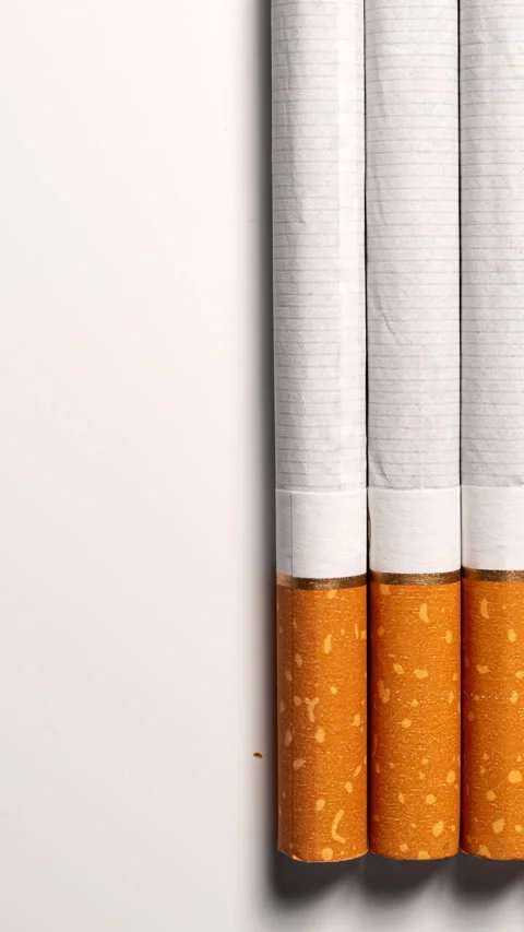 STOP MOTION: Filter cigarettes gradually disappear from the white surface Stock Footage 344860397