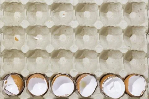 Stop motion flat lay of a box with broken eggshell brown chicken eggs Stock Photos