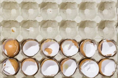 Stop motion flat lay of a box with broken eggshell brown chicken eggs Stock Photos