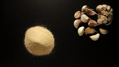 STOP MOTION: Garlic powder is piled up on the black table Stock Footage 108199248