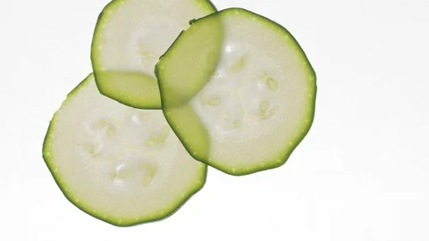 Stop motion how appear and filling all frame with zucchini slices on white table Stock Footage 108312026