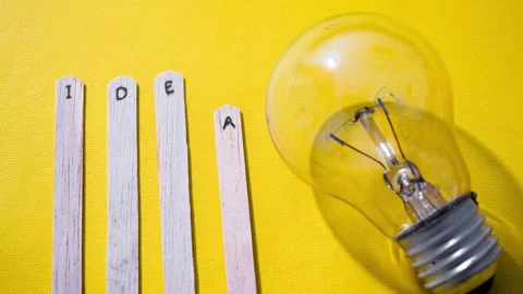 Stop motion Ice cream Stick with word Idea with lightbulb over yellow background Stock Footage 287781194
