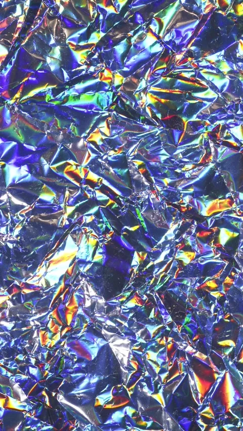 Stop Motion Loop of Shiny Crumpled Foil with Iridescent Holographic Surface Stock Footage 311501606