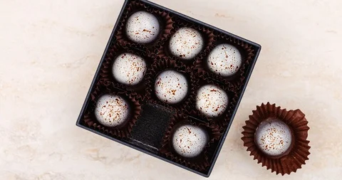 Stop motion luxury handmade chocolate candy decorated with paint spots in bla Stock Footage 111894048