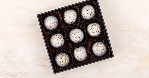 Stop motion luxury handmade chocolate candy decorated with paint spots in bla Stock Footage 111894065