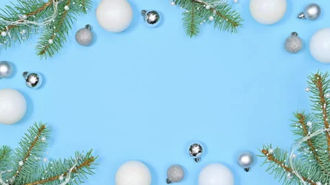Stop motion of making Christmas frame with fir twigs lights and white ornaments Stock Footage 163259045
