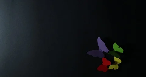 Stop motion motion of paper butterflies on a dark background. Stock Footage 122003432