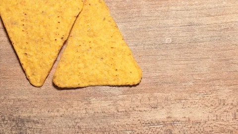 Stop motion movement the corn nachos chips on the table. Beautiful triangular Stock Footage 125894583