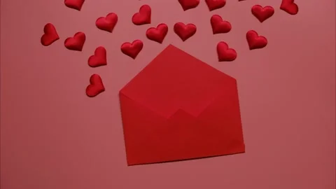 Stop motion of moving small red hearts in red envelope on pink background. Love Stock Footage 230111117