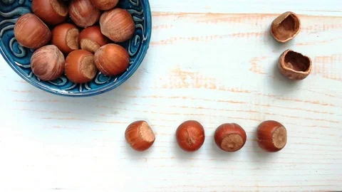 Stop motion nuts hazelnuts in blue bowl Stock Footage 117537981