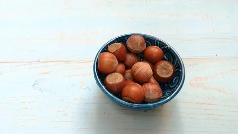 Stop motion nuts hazelnuts spin on a wooden table Stock Footage 117537985