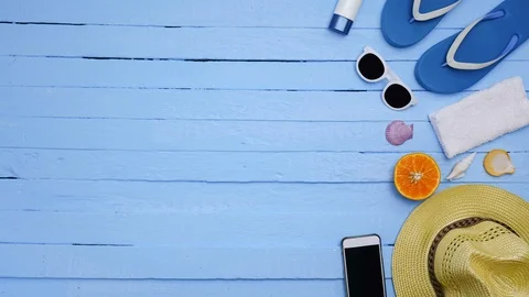 Stop motion - objects on a beach on blue background. Video stock 98437638