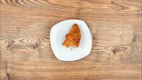 Stop Motion One delicious croissant on a plate Stock Footage 138867201
