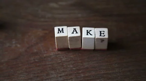 Stop motion of an optimistic sentence "make it real" with alphabet stamp, indoor Stock-Footage 56451037
