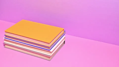 Stop Motion of Ordering Pastel Color Books on Pink Background Stock Footage 256107838