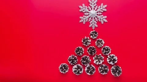 Stop motion. Pine cones falling from above and shape as Christmas tree Video stock 81869834