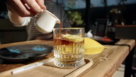 Stop motion of preparing espresso tonic drink. Pouring coffee into tonic in Stock Footage 224580592