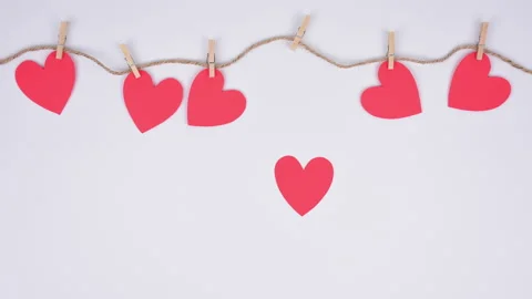 Stop motion red paper hearts fixed with clothespins on a cord. 動画素材 197015340