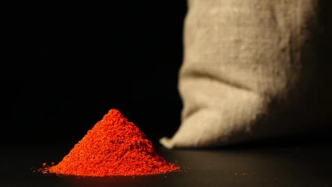 STOP-MOTION: Red pepper powder heap growing near a sac Stock Footage 91172856