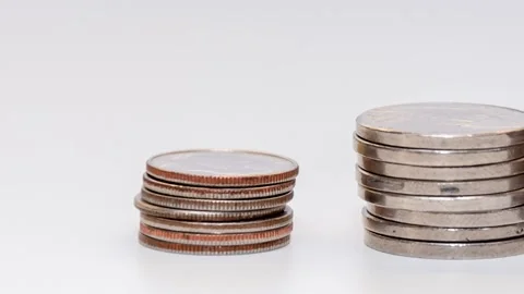 Stop motion reduces a stack of coins on a white background, camera movement. Con Stock Footage 205330407