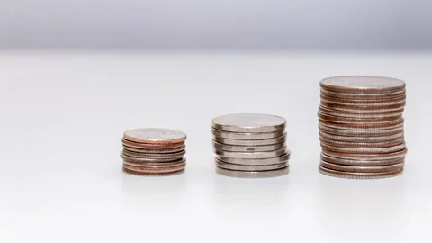 Stop motion reduces the stack of coins on a white background, the general plan.  Stock Footage 205330479
