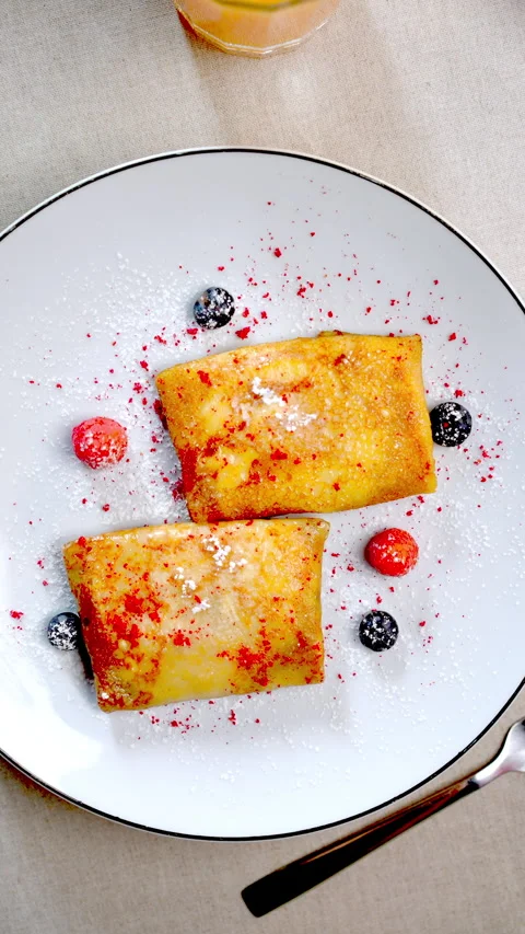 Stop motion revealing Ukrainian nalysnyky, traditional crepes topped with fresh Stock Footage 312381663