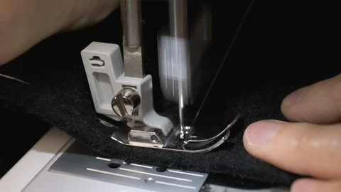 Stop motion shot of the process of sewing black fabric on the sewing machine Stock Footage 114623021