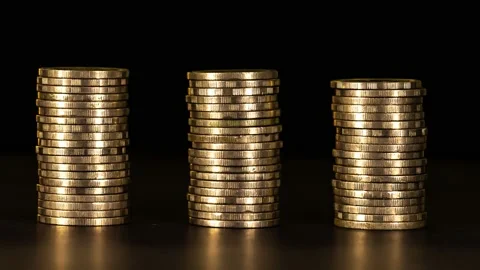 Stop motion shows the stack of three piles of gold cash coins Stock Footage 154365289